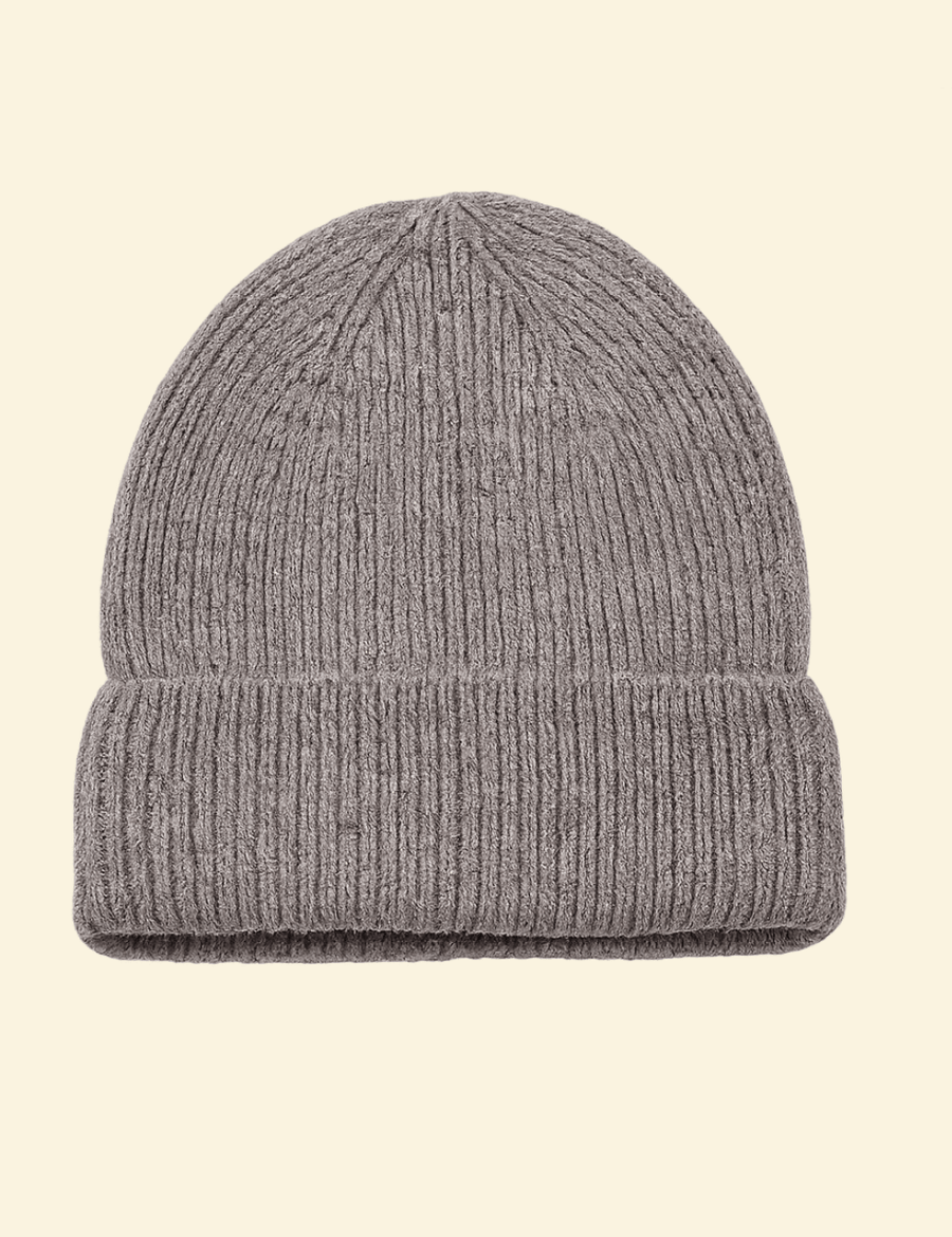 A deep grey ribbed knit beanie with a classic fold-over cuff, isolated on a soft cream background, showcasing its textured wool-blend fabric.