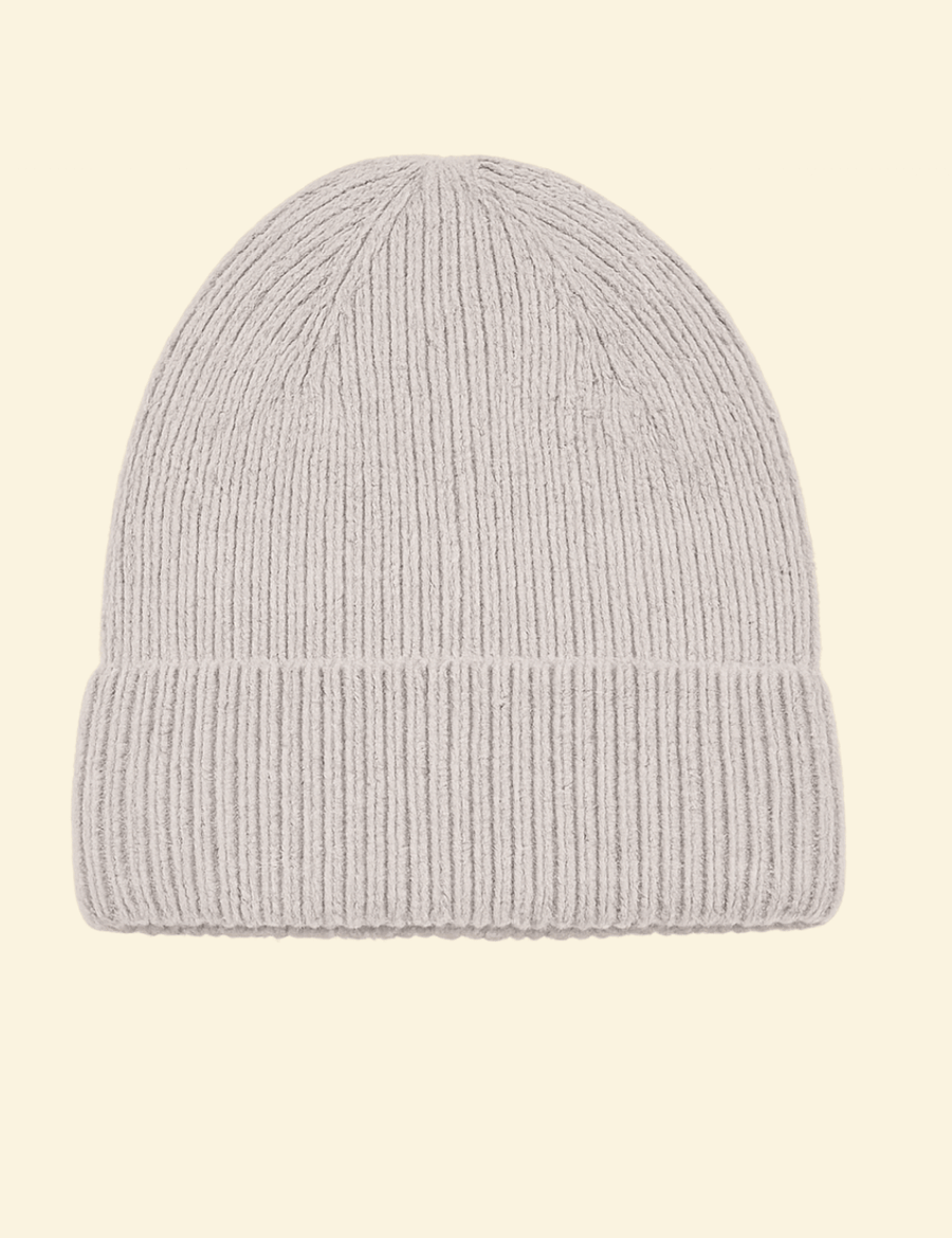 A soft, ribbed light grey knit beanie made from a premium cashmere-wool blend, displayed on a transparent background.