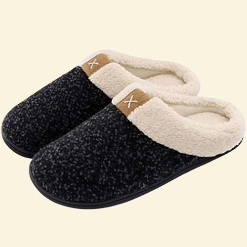 Charcoal memory foam slippers with cream sherpa lining and black sole on beige background