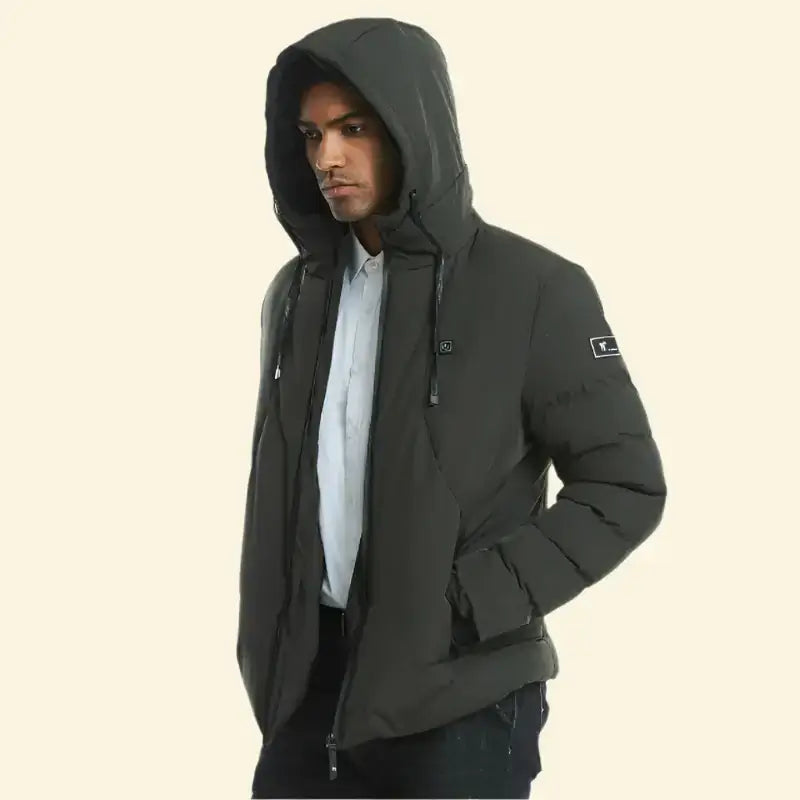 Model in dark green USB heated parka with hood up, hands in pockets