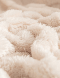 Detailed view of the soft checkered texture of the Warmweave blanket