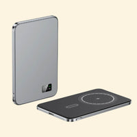 Two Grey slim wireless charging devices displayed on a beige background, showcasing front and top views with digital battery indicator and magnetic charging ring