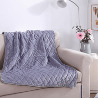 Ash Stone heated blanket shown on a modern chair with gentle folds