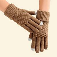 A pair of WarmWeave knit gloves in Sandstone brown featuring a diamond-knit texture and silver-tipped touchscreen fingertips, shown on a cream background.

