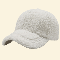 A crisp white wool-lined baseball cap in Snowdrift, offering clean winter style with plush insulation for cold days.



