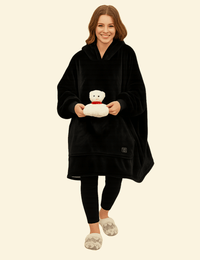 Woman wearing a black heated hoodie blanket with front pocket
