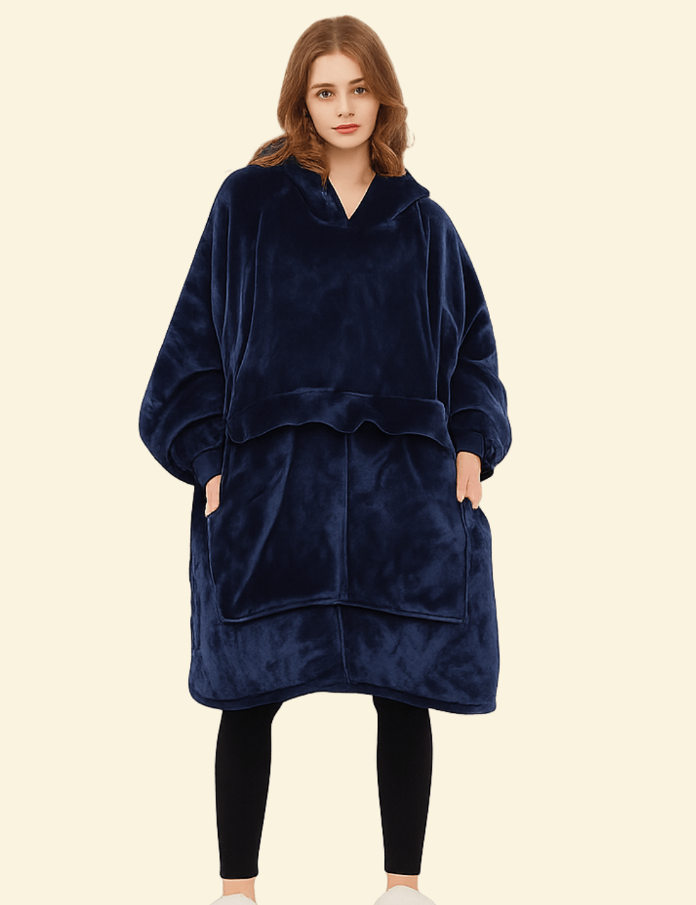 Woman wearing a navy blue oversized heated hoodie blanket with front pocket