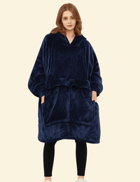 Woman wearing a navy blue oversized heated hoodie blanket with front pocket