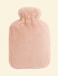 Soft pink Warmweave™ hot water bottle with cozy flannel cover, ideal for gentle heat therapy and comfort.