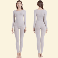 Woman wearing Warmweave™ light grey thermal underwear set, front and back view

