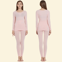 Woman modeling Warmweave™ pink thermal underwear set, front and back angles

