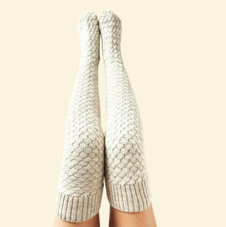 Pair of white Warmweave™ knee-high socks placed neatly against cream background