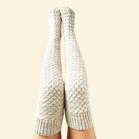 Pair of white Warmweave™ knee-high socks placed neatly against cream background