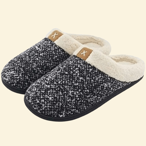 Ash memory foam slippers with cream sherpa lining and black sole on beige background
