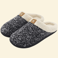 Ash memory foam slippers with cream sherpa lining and black sole on beige background
