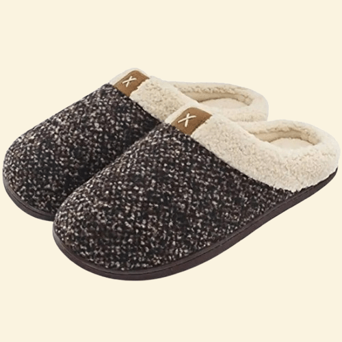 Cocoa Fleck memory foam slippers with cream sherpa lining and dark brown sole on beige background
